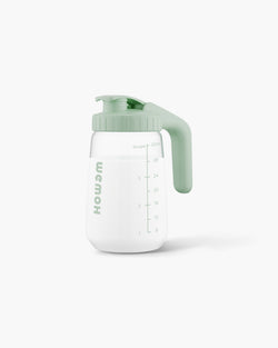 WEMOH P1 Original breast milk pitcher with green handle, 32oz glass body, measuring marks, and leakproof lid.