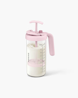 WEMOH P1 Plus glass formula mixing pitcher in pink with 32oz glass body, mixing handle, time dial, and measuring marks.